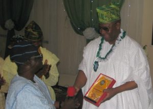 Barrister Tunde Braimoh receives his plaque from Prof Olufemi Omisore