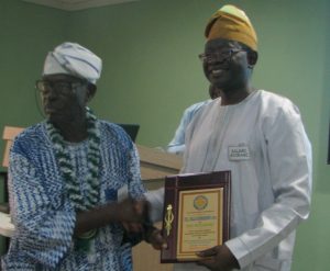 Colonel Bola Ogunsanwo, being handed a plaque to confirm his position as 'Mentor' of the Class set by Professor Ayobami Salami, the chairman of the set's School's Liaison Committee. He is also the Vice Chancellor of The Technical University, Ibadan (Tech-U)