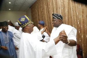 Senator Rilwan Adesoji Akanbi left watches as Governors Abiola Ajimobi and Akinwunmi Ambode exchange'comradeship' and fraternal greetings...