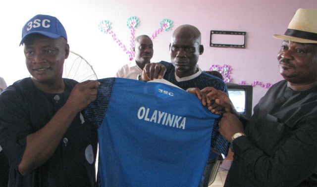 Olayinka Agboola, left, being presented his customized 3SC jersey by DJ Semight Semiu Adenekan... 