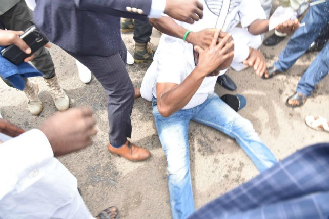 Governor Ayodele Fayose on the floor after being allegedly tear gassed by security agents