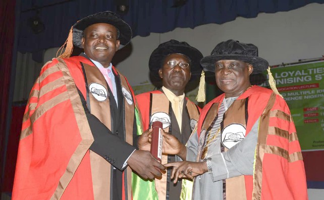 Professor Olutayo Adesinaleft receives his plaque