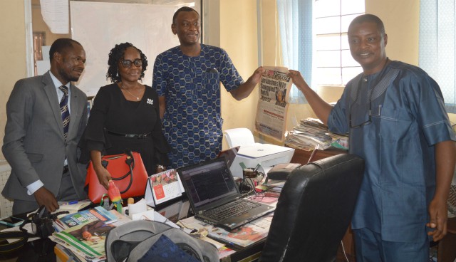 Mr Olayinka Agboola right presenting a copy of the very first edition of PMParrot Newspaper to his visitorsduring the visit