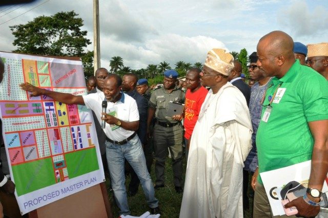 …The representative of Songhai Farms (Porto-Novo), Mr Sintoudi Chainlenane (left) showing the master plan of how Pacesetter Farms (Songhai model) will be operated to Oyo State Governor, Senator Abiola Ajimobi and Special Adviser on Agriculture, Prof Olusegun Adekunle at the farm…