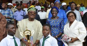 Nostalgia As Ajimobi Presents Trophy To Lagelu Grammar School, His Alma Mater On Children’s Day L-R: Oyo State Governor, Senator Abiola Ajimobi (second row) presents trophy of first position to Lagelu Grammar School, Ibadan; Commissioner for Women Affairs, Social Development and Poverty Alleviation, Mrs Atinuke Oshunkoya; and the ministry's Permanent Secretary, Mrs Folusho Sali, at this year's Children day march past held at the Lekan Salami Stadium, Ibadan...on Saturday