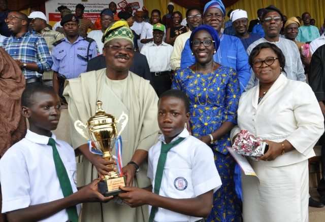 L-R: Oyo State Governor, Senator Abiola Ajimobi (second row) presents trophy of first position to Lagelu Grammar School, Ibadan; Commissioner for Women Affairs, Social Development and Poverty Alleviation, Mrs Atinuke Oshunkoya; and the ministry's Permanent Secretary, Mrs Folusho Sali, at this year's Children day march past held at the Lekan Salami Stadium, Ibadan...on Saturday
