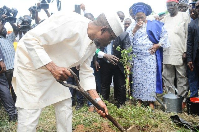 Osun’s Governor Rauf Aregbesola completing the process of planting one of the 60 trees at 60 Trees for Aregbesola at 60 program organised by the Osun State Broadcasting Corporation (OSBC) Osogbo. Watching him is his Deputy Mrs. Grace Titi-Laoye Tomori and others at the event…