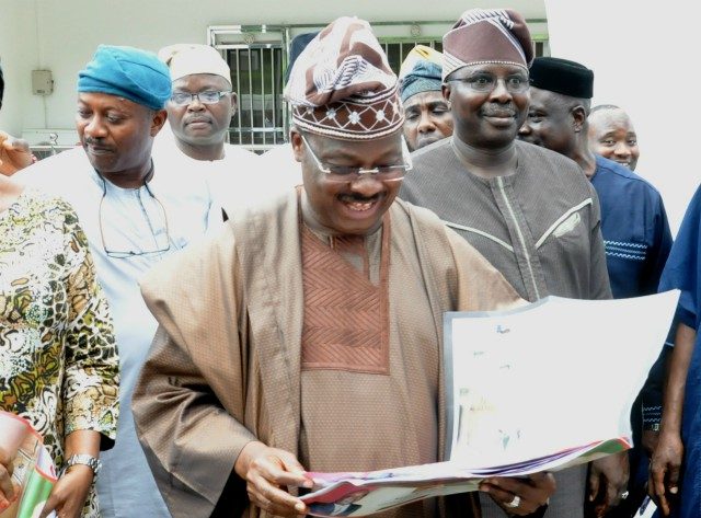 Governor Abiola Ajimobi...going through one of the editions of our sister publication, Parrot Xtra Magazine...to his left is Prof Adeniyi Olowofela, his Commissioner for Education...