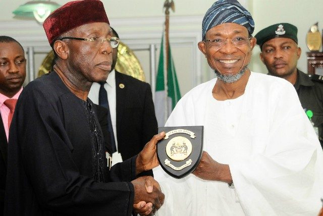 Minister of Agriculture, Chief Audu Ogbhe, receiving the State emblem from Governor State of Osun, Ogbeni Rauf Aregbesola, during a courtesy visit by the minister and his entourage to Osogbo...