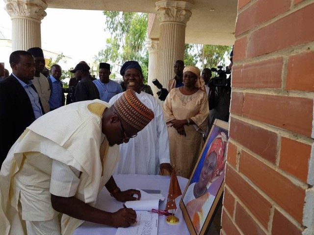 Governor Abdulfatah Ahmed...signing the condolence register while Chief Bisi Akande looks on...