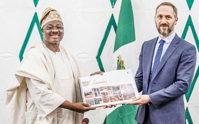 Oyo State Governor, Senator Abiola Ajimobi, left, receiving the final draft copy of the Ibadan city master plan from the representative of Design and Architecture Bureau Consulting Engineers (dar)/ Project Manager, Mr Yann Leclerq, at the Governor's Office, Ibadan...