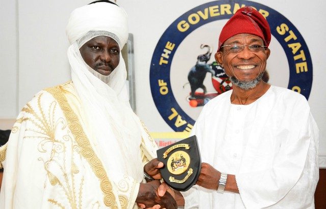 Governor State of Osun, Ogbeni Rauf Aregbesola, right, presenting a plaque to the Emir of Borgu during the visit…at the Government House, Osogbo…