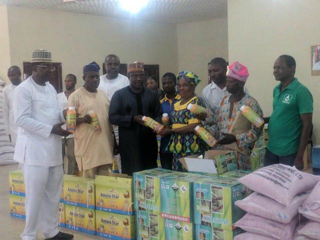 Kwara State government officials with the farmers during the presentation...