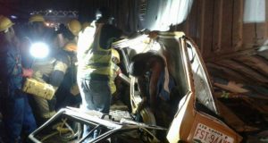 Tragedy In Lagos: Container Falls On Two Fully Loaded Buses ...one of the buses with a body of one of the victims hanging...