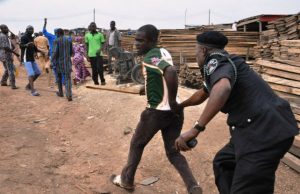 Ajimobi’s Closure Order: Plank Market Traders Protest ...a police officer here 'deals' with a plank market protester in Ibadan...