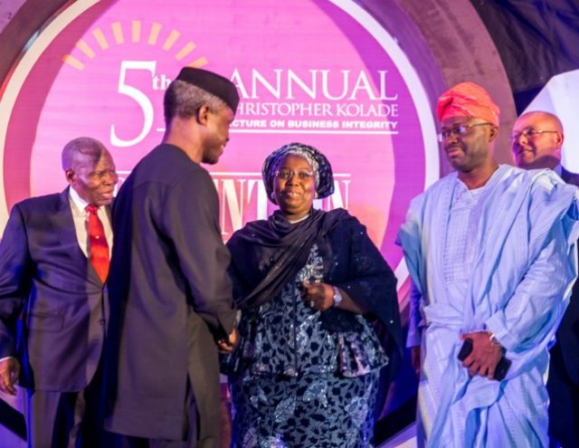 Acting President Yemi Osinbajo shaking hands with Deputy Governor of Lagos State, Dr. Idiat Oluranti Adebule while Dr Christopher Kolade, left, and others look on...at the event...