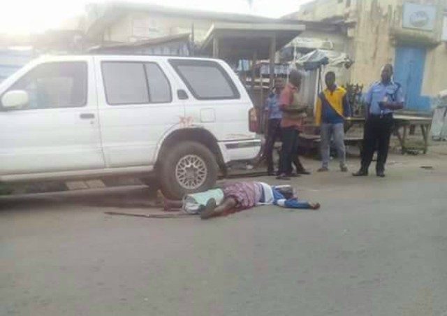 ...the remains of the aged woman killed by rampaging drivers lying on the street in Osogbo...
