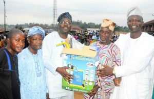 Osun Legislator Identifies How Poverty Can Be Alleviated Chairman Osun House of Assembly Committee on Information and Strategy, Honourable Olatunbosun Oyintiloye (3rd right); Owalare of Ilare-Ijesa, Oba Emmanuel Otebolaku (2nd right) presenting a plasma television with DSTV decoder to the Chairman, Iketewi Youths Forum, Sule Raimi, during Oyintiloye's ward to ward Empowerment programme for farmers, widows and others, at Ilare Ward 10 of Obokun East Local Council Development Area (LCDA) of Osun…during the week…