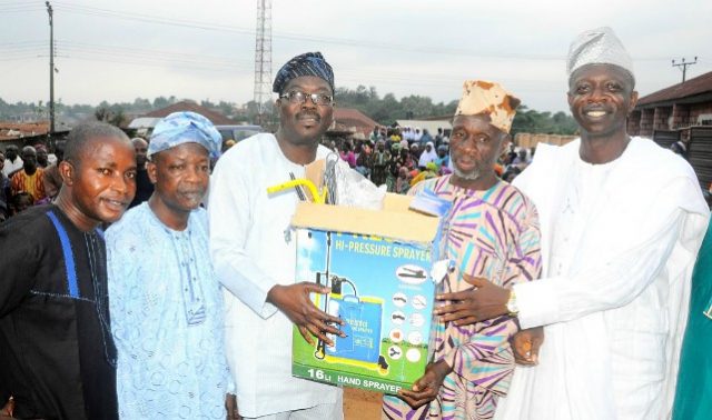 Chairman Osun House of Assembly Committee on Information and Strategy, Honourable Olatunbosun Oyintiloye (3rd right); Owalare of Ilare-Ijesa, Oba Emmanuel Otebolaku (2nd right) presenting a plasma television with DSTV decoder to the Chairman, Iketewi Youths Forum, Sule Raimi, during Oyintiloye's ward to ward Empowerment programme for farmers, widows and others, at Ilare Ward 10 of Obokun East Local Council Development Area (LCDA) of Osun…during the week…
