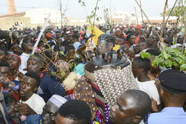 ...a masquerade in Iwo, Osun State, with its followers...