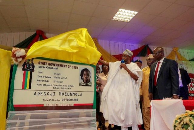 Ogbeni Rauf Aregbesola unveils the card…with him is Managing Director, Chams, Mr.Femi Williams and others, at Ilesa Government High School, Ilesa…
