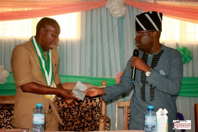 Senator Rilwan Adesoji Akanbi, right, giving out a cheque to the representative of ANCOPSS during the meeting...