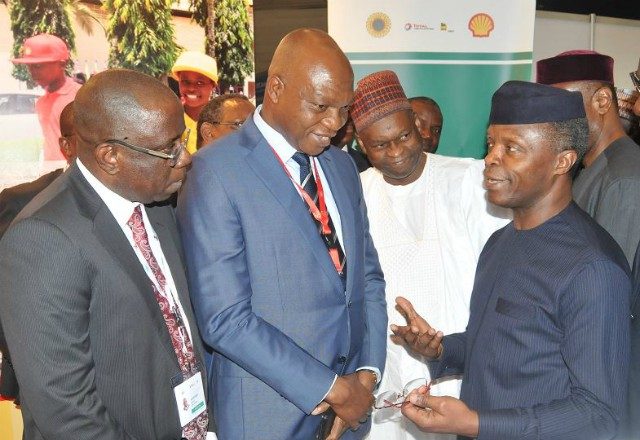 L-R: Managing Director, Shell Nigeria Exploration and Production Company, Bayo Ojulari; and the Managing Director, The Shell Petroleum Development Company of Nigeria (SPDC) Ltd and Country Chair, Shell Companies in Nigeria, Osagie Okunbor, receiving Chairman, Nigeria Economic Summit Group, Bukar Kyari and the Vice President, Prof. 'Yemi Osinbajo at the Shell exhibition…