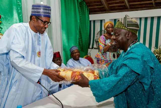 President Muhammadu Buhari receives a gift from the representatives of Nigerians in the diaspora in Abidjan…