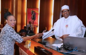 Photo: Buhari Swears In New Permanent Secretaries President Muhammadu Buhari, right, congratulating one of the lucky Permanent Secretaries...