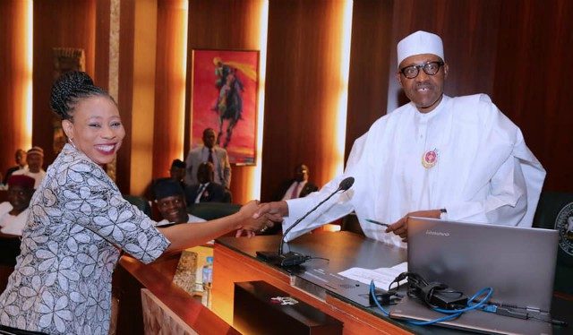 President Muhammadu Buhari, right, congratulating one of the lucky Permanent Secretaries...