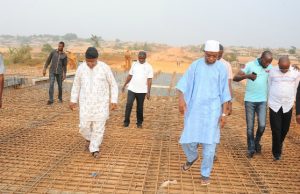 Destruction Of Bridges In Osun: Government Fingers Opposition Governor Rauf Aregbesola, in white cap, during an inspection tour of one of the bridges under construction...