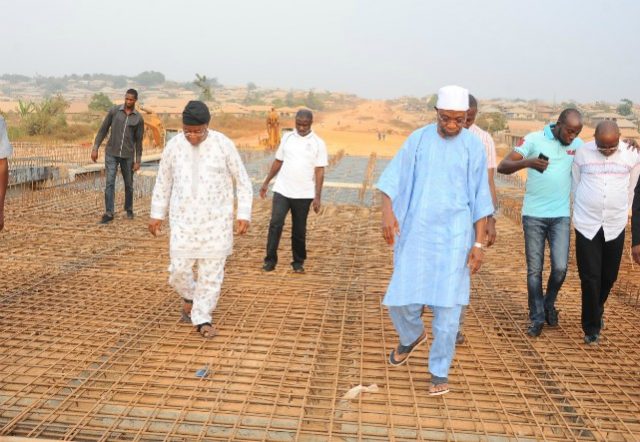 Governor Rauf Aregbesola, in white cap, during an inspection tour of one of the bridges under construction...