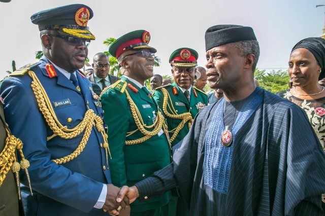 Vice President Yemi Osinbajo and wife, right, being welcomed to the event by Service Chiefs...