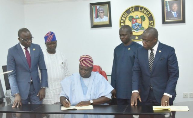 Lagos State Governor Akinwunmi Ambode (middle), signing the Seven bills into Law in his Office at the Lagos House, Ikeja, on Thursday, February 8, 2018. With him are Attorney General/Commissioner for Justice, Mr. Adeniji Kazeem (right); Commissioner for Energy & Mineral Resources, Mr. Olawale Oluwo (2nd right); Commissioner for Information & Strategy, Mr. Kehinde Bamigbetan (2nd left) and Commissioner for Finance, Mr. Akinyemi Ashade (left)…