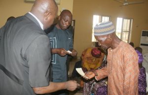 Pensioners’ Payment Begins In Osun State, Cheques Given Out To 2,006 ...one of the Osun State pensioners taking his cheque...