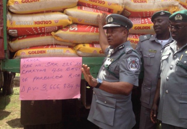 Customs Area Comptroller Oyo/Osun Command, Mr,Christopher Odibu showing Seized imported smuggled rice to newsmen at the Customs Headquarters Agodi, Ibadan...