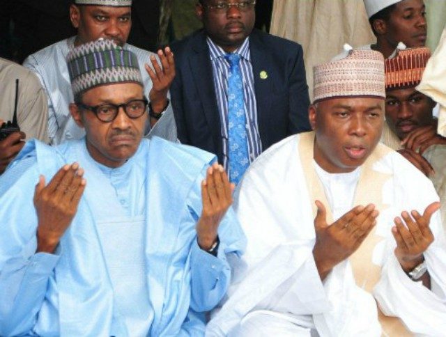 President Muhammadu Buhari, left, with Senator Bukola Saraki...praying for the dead...