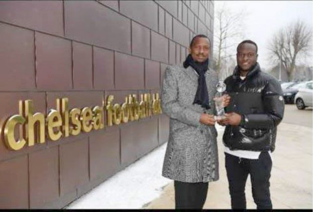 Shehu Dikko, left, presents Victor Moses with his gong...