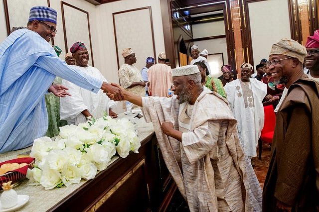 President Muhammadu Buhari, left, being greeted by Senator Sola Adeyeye...