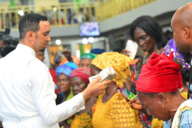 Dr Chris Okafor, left, giving out to widows...