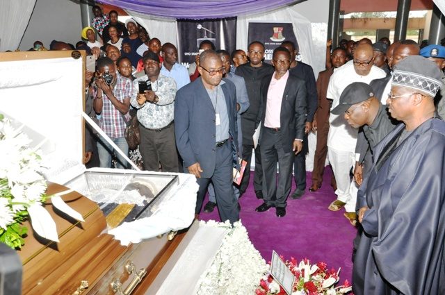 Governor Abiola Ajimobi, right, paying his last respect to the remains of Hon Michael Adeyemo...