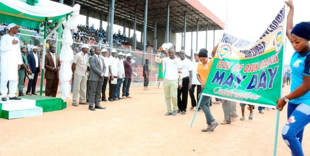 Osun's Governor Rauf Aregbesola, left, at the stadium in solidarity with workers on May-Day...