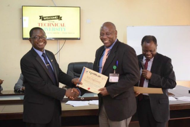 The Vice-Chancellor, Professor Ayobami Salami (left) presenting a certificate to Mr. Dipo Fagbamila after the workshop