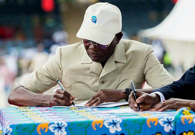 Adams Oshiomhole...signing in as new APC Chairman...