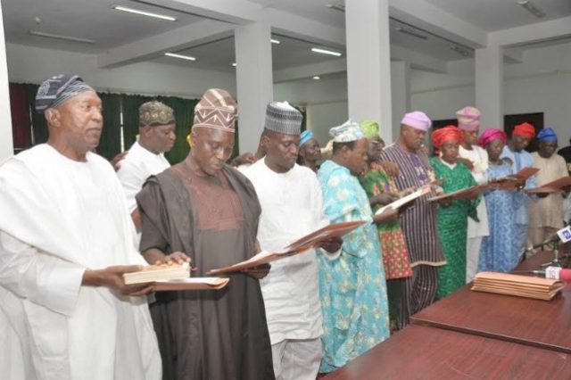 Left, Chief Omokunmi Mustapha, the Chairman of the new Oyo PDP exco, being sworn in with others...