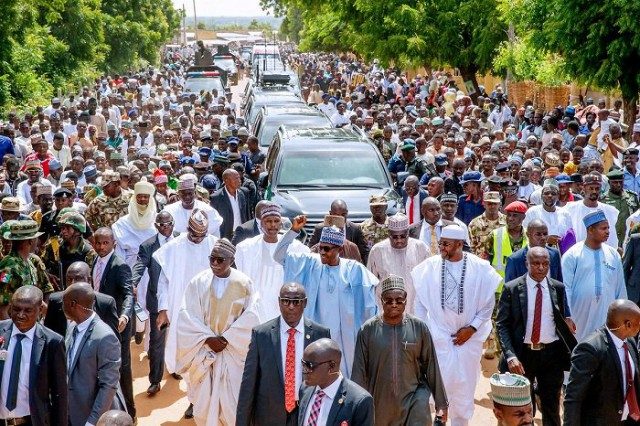 President Muhammadu Buhari, middle, trekking with his admirers...