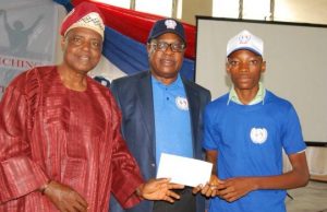 Eruwa Students Excited With Foundation’s Cash Awards A student gets his cash award...