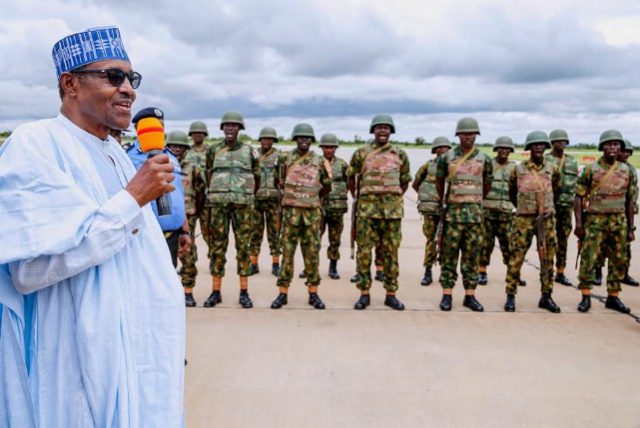 President Muhammadu Buhari, left, addressing the troops...