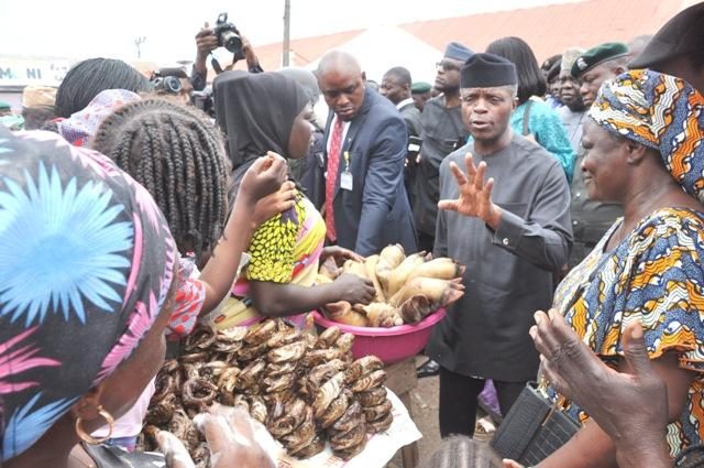 Vice President Yemi Osinbajo, second from the right, with traders at the market on Thursday…