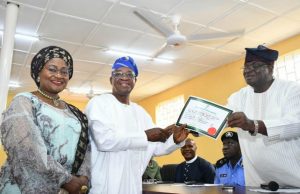 INEC Gives Out Certificate Of Return To Oyetola, Osun’s Governor-Elect National Commissioner of Independent National Electoral Commission (INEC), Prince Adedeji Soyebi (right), presenting the Certificate of Return to Osun Governor-Elect, Alhaji Isiaka Gboyega Oyetola (middle): with them is Oyetola's wife, Alhaja Kafayat (left)